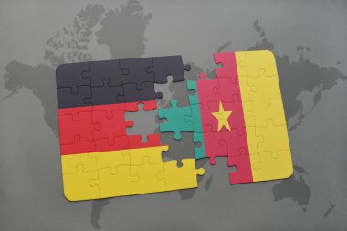 bir dünya haritası arka plan üzerinde Almanya ve Kamerun ulusal bayrağı ile bulmaca.