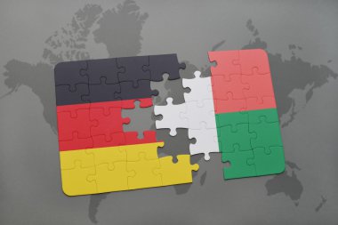 bir dünya haritası arka plan üzerinde Almanya ve madagaskar ulusal bayrağı ile bulmaca.