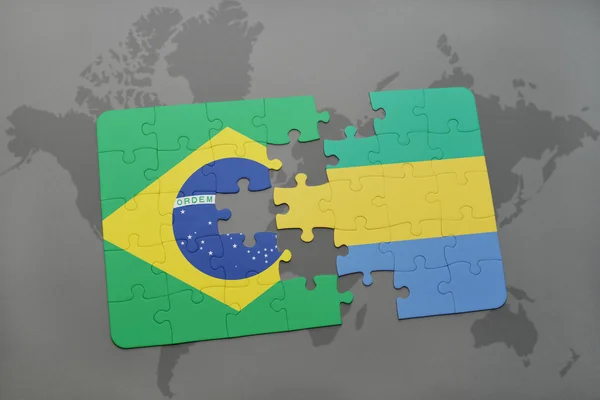 stock image puzzle with the national flag of brazil and gabon on a world map background.