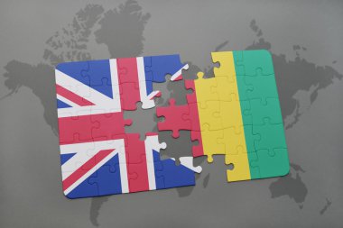 bir dünya haritası arka plan üzerinde büyük Britanya ve Gine ulusal bayrağı ile bulmaca.