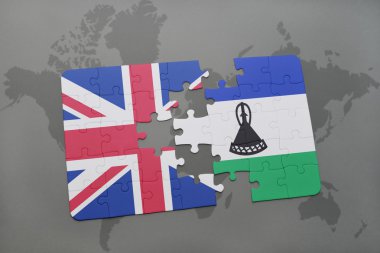 bir dünya haritası arka plan üzerinde büyük Britanya ve lesotho ulusal bayrağı ile bulmaca.