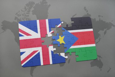 bir dünya haritası arka plan üzerinde büyük Britanya ve güney sudan ulusal bayrağı ile bulmaca.