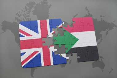 bir dünya haritası arka plan üzerinde büyük Britanya ve Sudan ulusal bayrağı ile bulmaca.