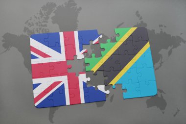 bir dünya haritası arka plan üzerinde büyük Britanya ve Tanzanya ulusal bayrağı ile bulmaca.