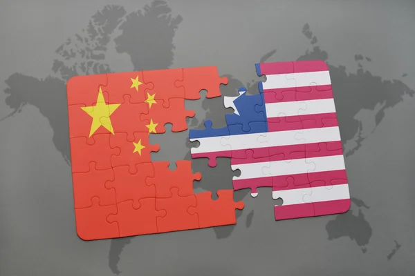 Puzzle with the national flag of china and liberia on a world map background. — Stock Photo, Image