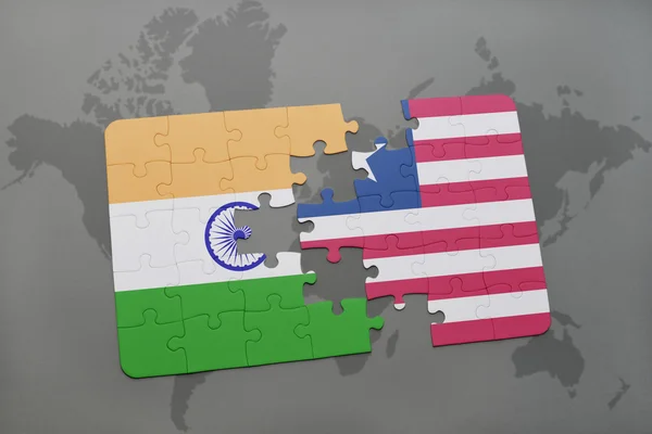 Puzzle with the national flag of india and liberia on a world map background. — Stock Photo, Image