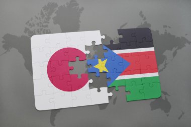 bir dünya haritası arka plan üzerinde Japonya ve Güney Sudan ulusal bayrağı ile bulmaca.