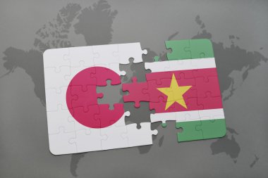 bir dünya haritası arka plan üzerinde japonya ve surinam ulusal bayrağı ile bulmaca.