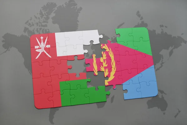 Puzzel met de nationale vlag van Oman en Eritrea op een wereld kaart achtergrond. — Stockfoto