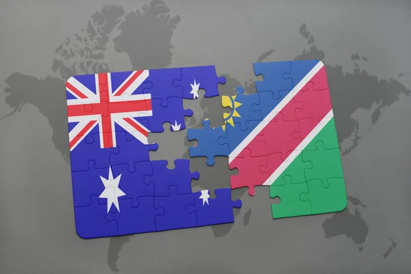 Rompecabezas con la bandera nacional de Australia y Namibia en un mapa del mundo fondo . — Foto de Stock