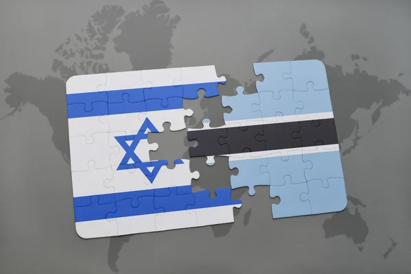 Puzzle with the national flag of israel and botswana on a world map background. — Stock Photo, Image