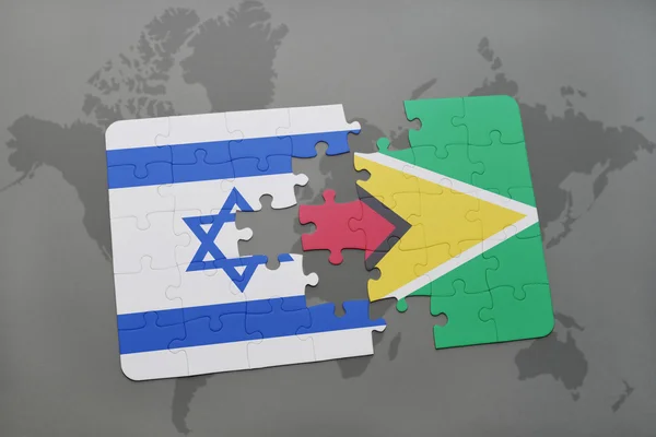Puzzle with the national flag of israel and guyana on a world map background. — Stock Photo, Image