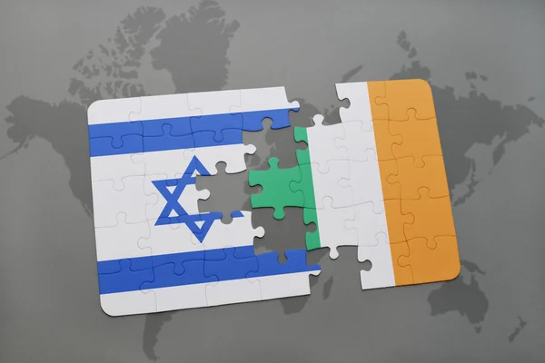 Puzzle with the national flag of israel and ireland on a world map background. — Stock Photo, Image