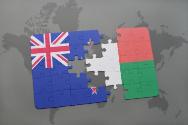 bir dünya haritası arka plan üzerinde Yeni Zelanda ve madagaskar ulusal bayrağı ile bulmaca.