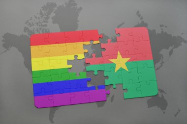 bir dünya haritası arka plan üzerinde burkina faso ve eşcinsel gökkuşağı bayrağı ulusal bayrağı ile bulmaca.