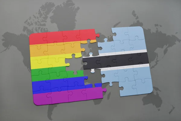 Puzzle with the national flag of botswana and gay rainbow flag on a world map background. — Stock Photo, Image