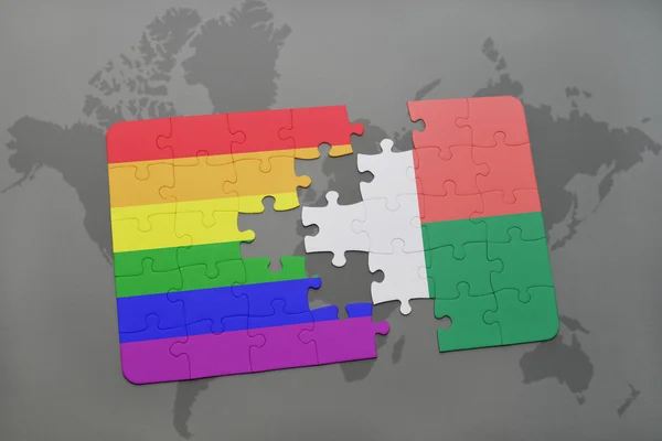 Hádanka s národní vlajkou Madagaskaru a vlajka gay duhové na mapě světového mapování. — Stock fotografie