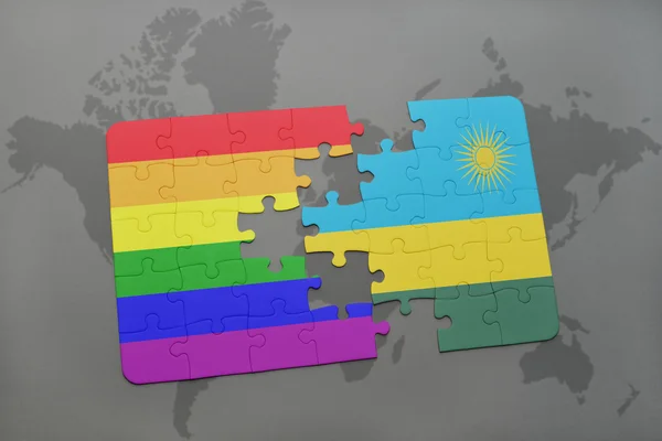 Puzzle with the national flag of rwanda and gay rainbow flag on a world map background. — Stock Photo, Image