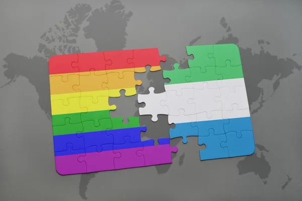 Puzzel met de nationale vlag van Sierra Leone en Gay regenboog vlag op een wereld kaart achtergrond. — Stockfoto