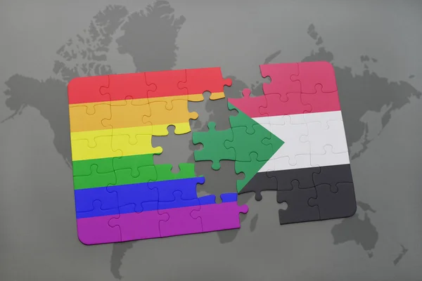Puzzle with the national flag of sudan and gay rainbow flag on a world map background. — Stock Photo, Image