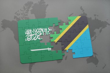 bir dünya haritası arka plan üzerinde Suudi Arabistan ve Tanzanya ulusal bayrağı ile bulmaca.