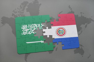 bir dünya haritası arka plan üzerinde Suudi Arabistan ve Paraguay ulusal bayrağı ile bulmaca.