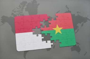 bir dünya haritası arka plan üzerinde endonezya ve burkina faso ulusal bayrağı ile bulmaca.