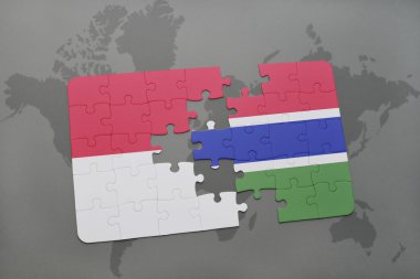 bir dünya haritası arka plan üzerinde endonezya ve gambiya ulusal bayrağı ile bulmaca.