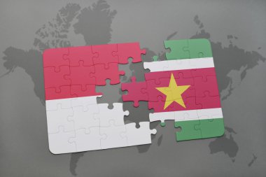bir dünya haritası arka plan üzerinde endonezya ve surinam ulusal bayrağı ile bulmaca.