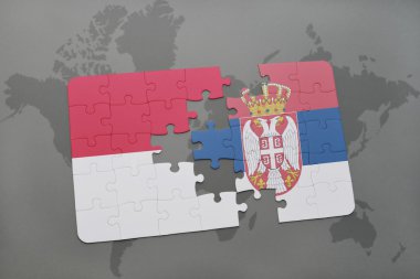 bir dünya haritası arka plan üzerinde endonezya ve sırbistan ulusal bayrağı ile bulmaca.