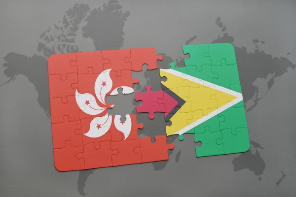 Puzzle a nemzeti zászló Hongkong és Guyana a világtérképen háttér. — Stock Fotó