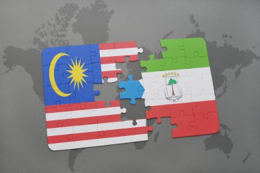 bir dünya haritası arka plan üzerinde malezya ve ekvator ginesi ulusal bayrağı ile bulmaca.
