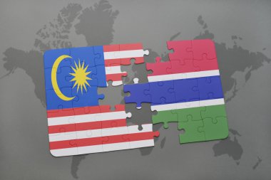 bir dünya haritası arka plan üzerinde malezya ve gambiya ulusal bayrağı ile bulmaca.
