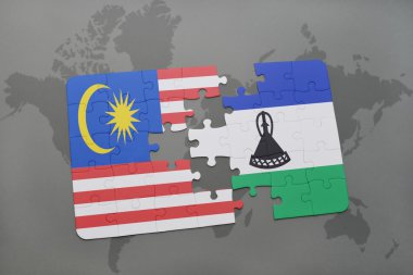 bir dünya haritası arka plan üzerinde malezya ve lesotho ulusal bayrağı ile bulmaca.