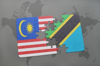 bir dünya haritası arka plan üzerinde malezya ve tanzanya ulusal bayrağı ile bulmaca.