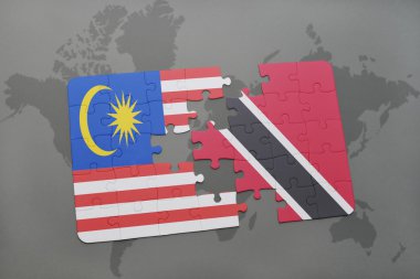 malezya ve trinidad ve tobago ulusal bayrağı ile bulmaca bir dünya haritası arka plan üzerinde.