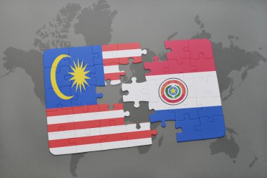 bir dünya haritası arka plan üzerinde malezya ve paraguay ulusal bayrağı ile bulmaca.