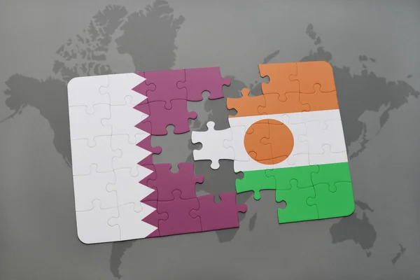 Puzzle with the national flag of qatar and niger on a world map background. — Stock Photo, Image
