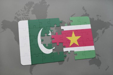 bir dünya haritası arka plan üzerinde pakistan ve surinam ulusal bayrağı ile bulmaca.