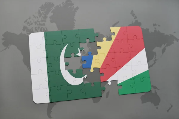 Puzzle with the national flag of pakistan and seychelles on a world map background. — Stock Photo, Image