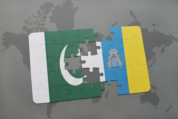 Puzzle with the national flag of pakistan and canary islands on a world map background. — Stock Photo, Image