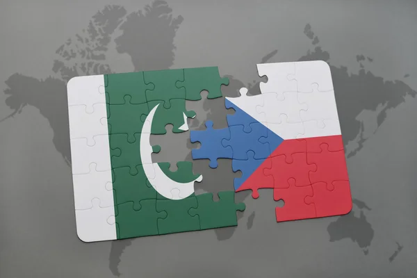 Puzzle with the national flag of pakistan and czech republic on a world map background. — Stock Photo, Image