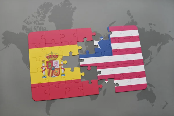 世界地图背景上西班牙和利比里亚国旗的拼图. — 图库照片