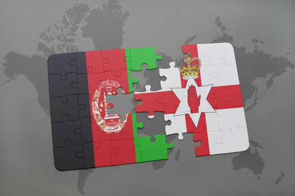 puzzle with the national flag of afghanistan and northern ireland on a world map background.