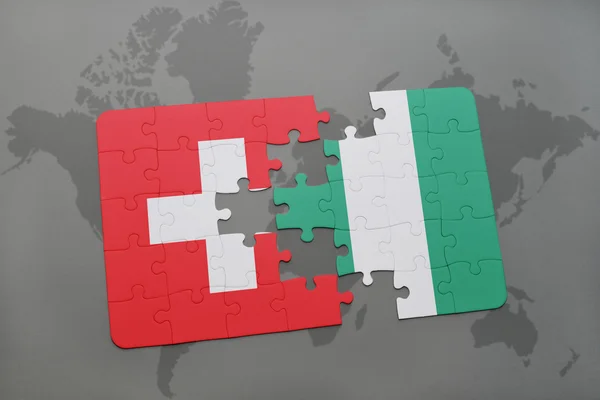 Bir dünya haritası arka plan üzerinde İsviçre ve Nijerya ulusal bayrağı ile bulmaca. — Stok fotoğraf