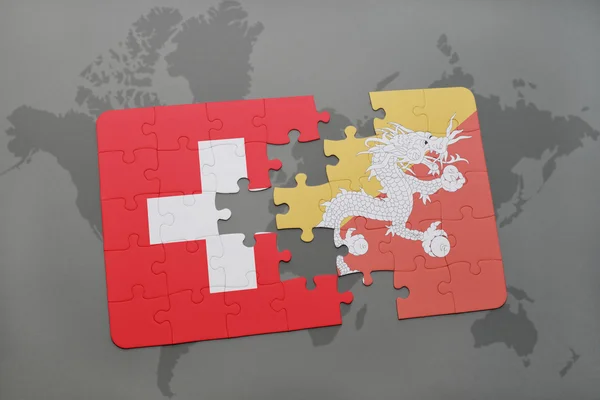 Puzzel met de nationale vlag van Zwitserland en Bhutan op een wereld kaart achtergrond. — Stockfoto