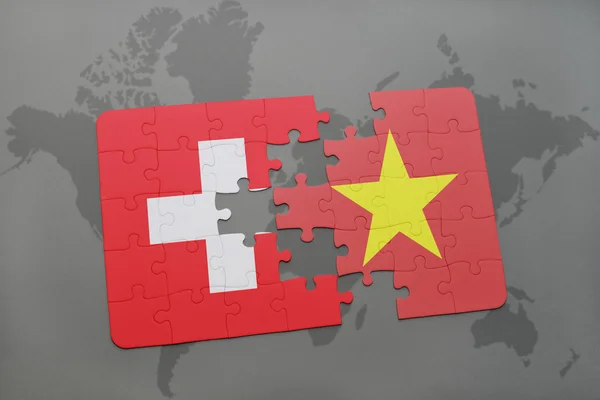 Головоломка з Національний прапор Швейцарії та В'єтнам на фоні карта світу. — стокове фото