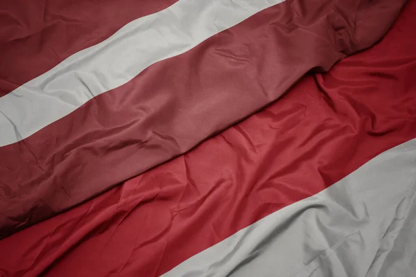 Waving Colorful Flag Indonesia National Flag Latvia Macro — Stock Photo, Image