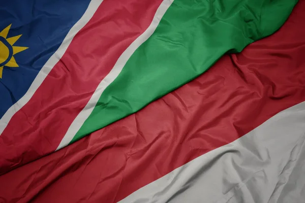 インドネシアのカラフルな旗とナミビアの国旗を振っています マクロ — ストック写真