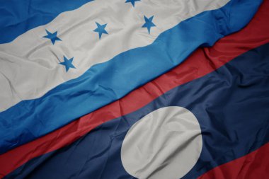 Laos 'un renkli bayrağı ve Honduras' ın ulusal bayrağı sallanıyor. makro